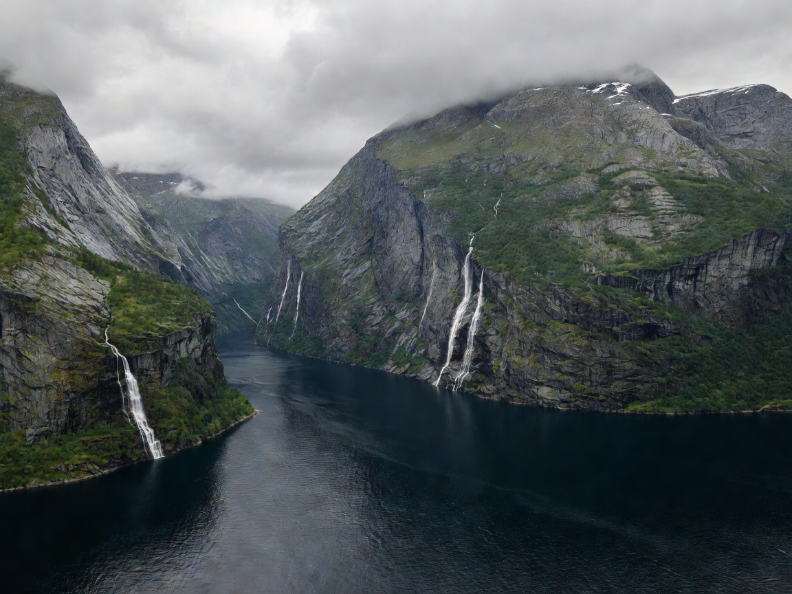 Norwegian Fjord dramatic waterfalls and mountain landscape with cruise line